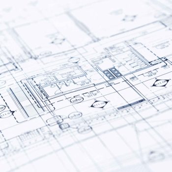 A close-up view of architectural blueprints with detailed technical drawings and construction schematics.